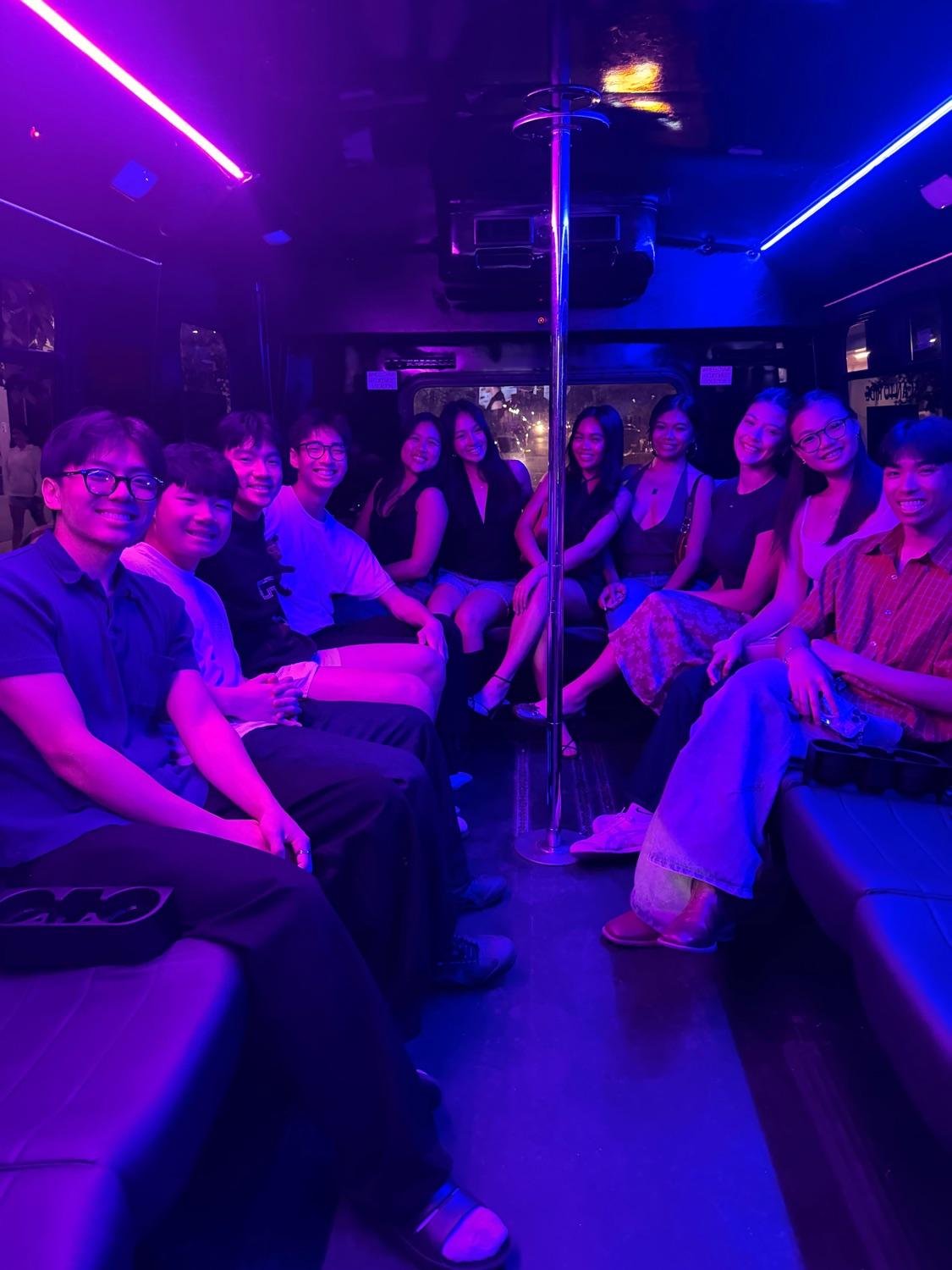 Diverse group of friends riding AUX under purple lighting